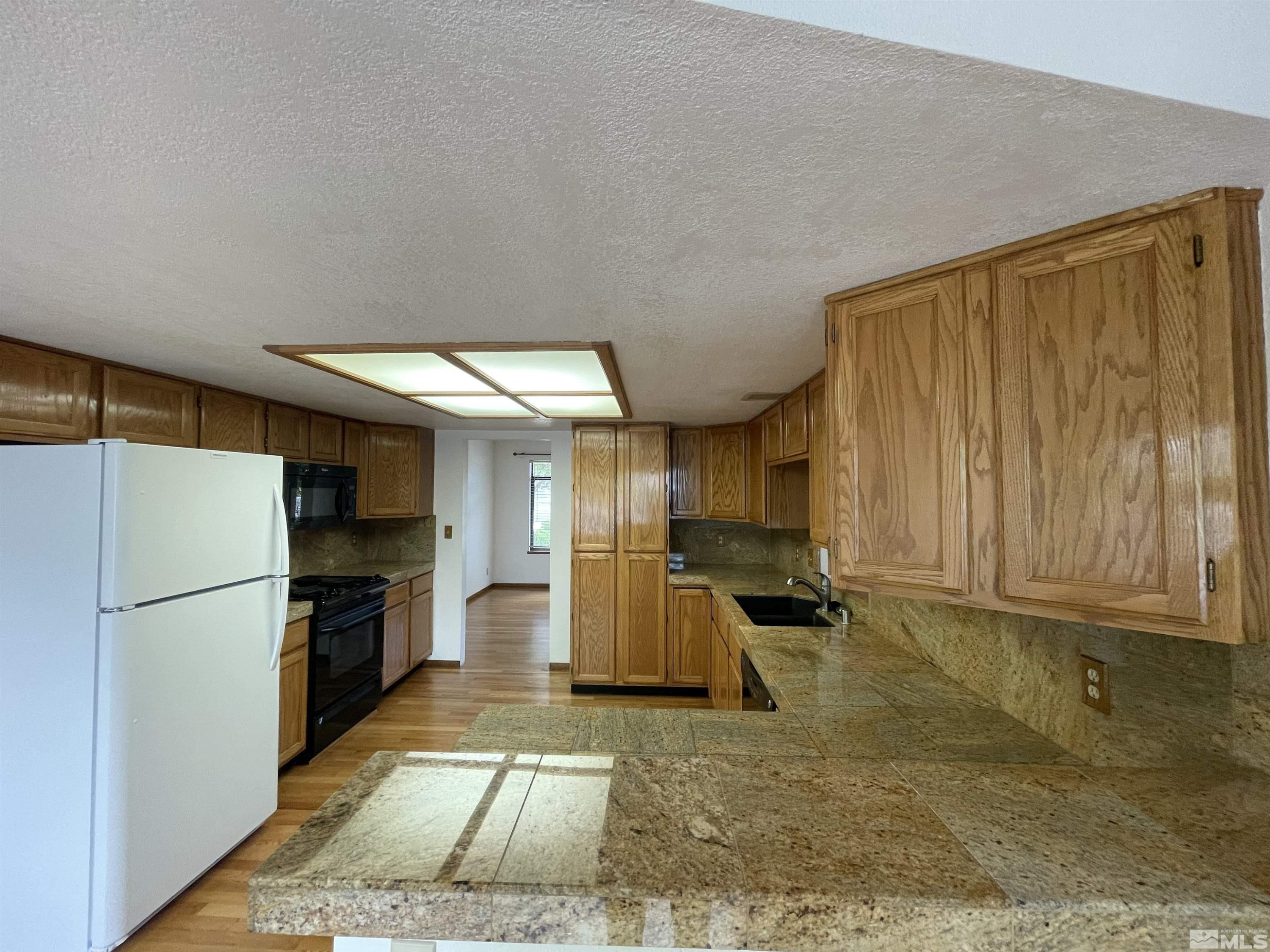 2500 Bryce Canyon Lane Reno, NV 89509 - Photo 11 of 23 a kitchen with refrigerator and cabinets