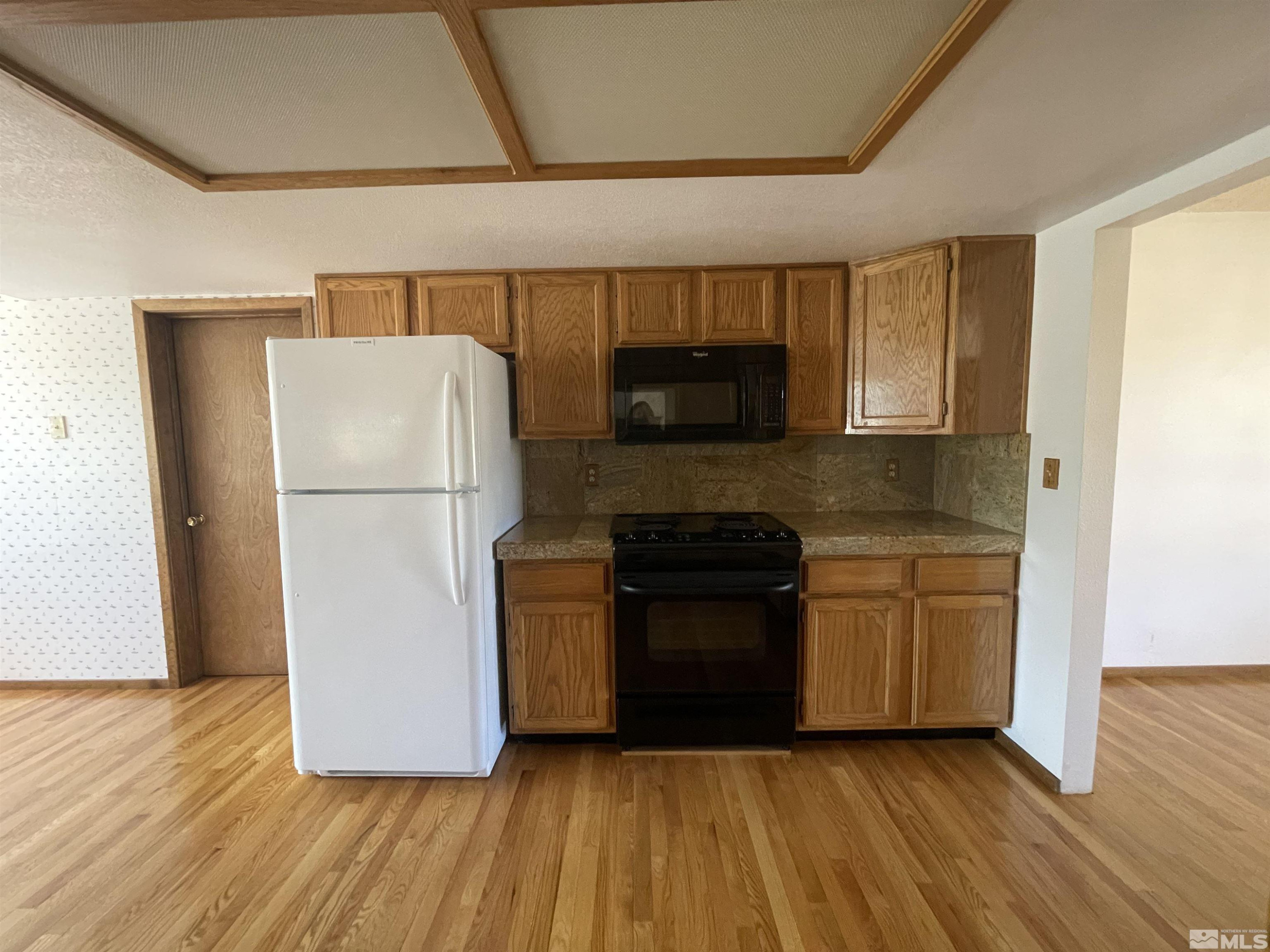 2500 Bryce Canyon Lane Reno, NV 89509 - Photo 12 of 23 a kitchen with a refrigerator and a stove top oven