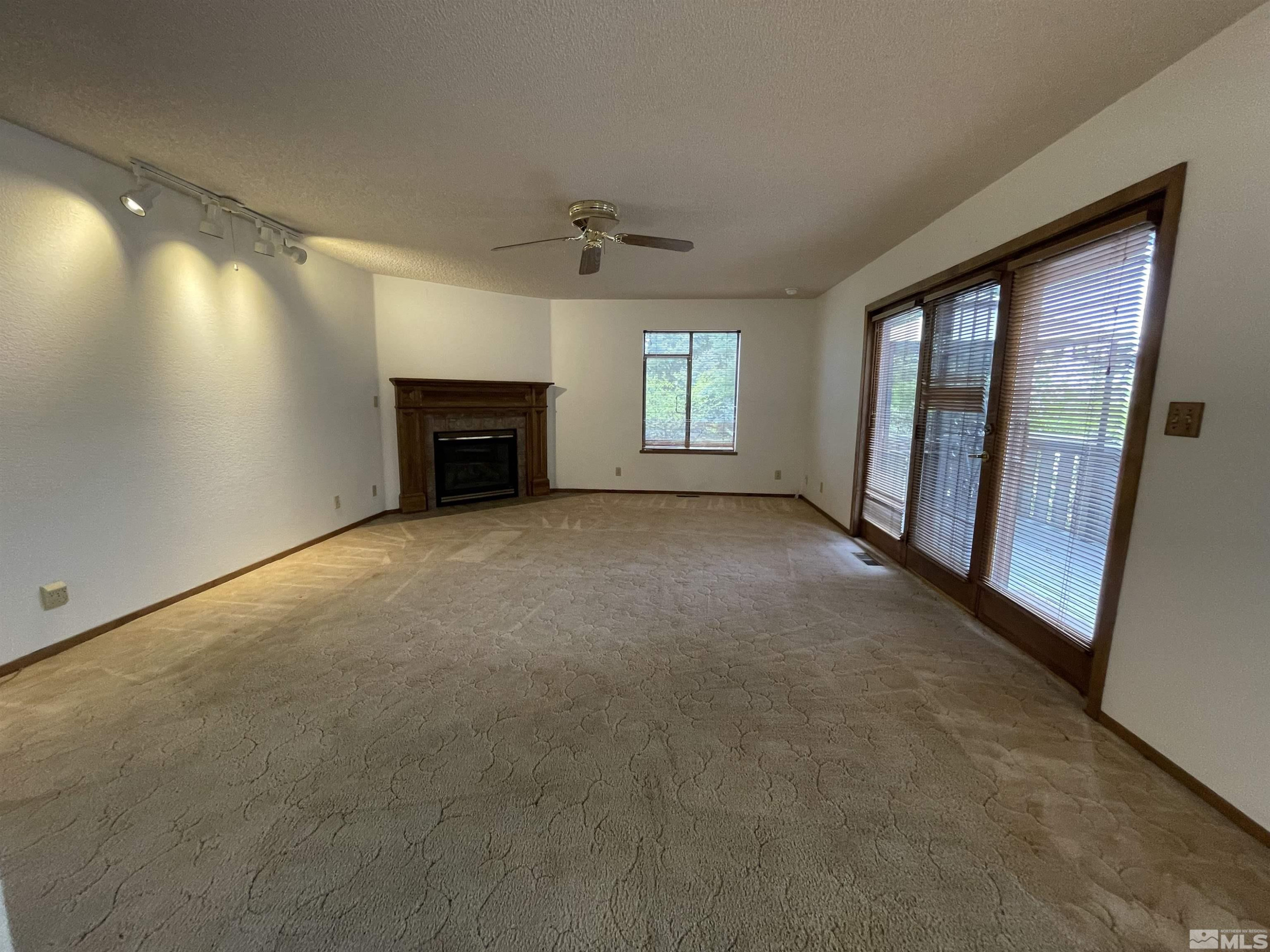 2500 Bryce Canyon Lane Reno, NV 89509 - Photo 13 of 23 an empty room with windows and fireplace