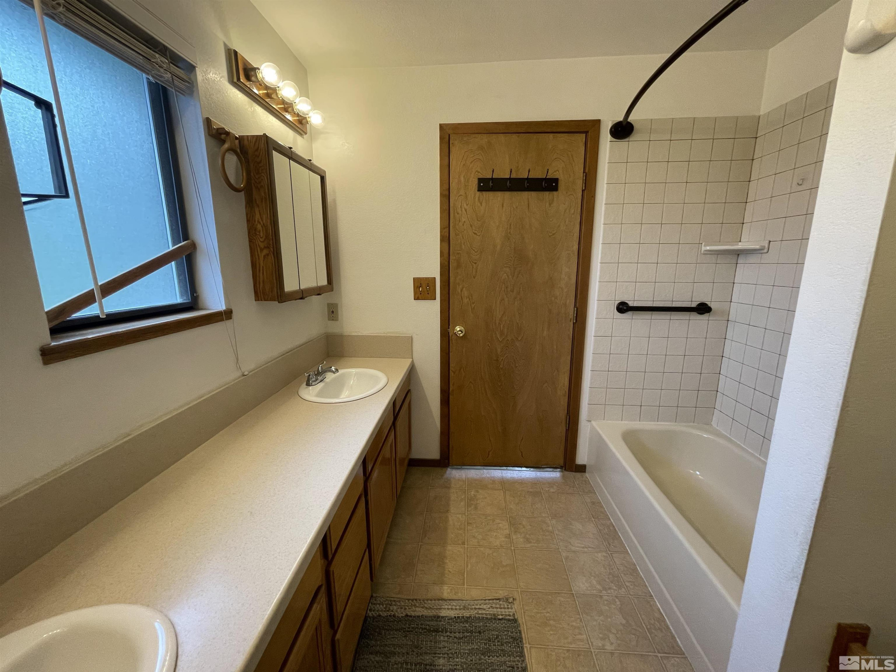 2500 Bryce Canyon Lane Reno, NV 89509 - Photo 18 of 23 a bathroom with a tub sink and mirror