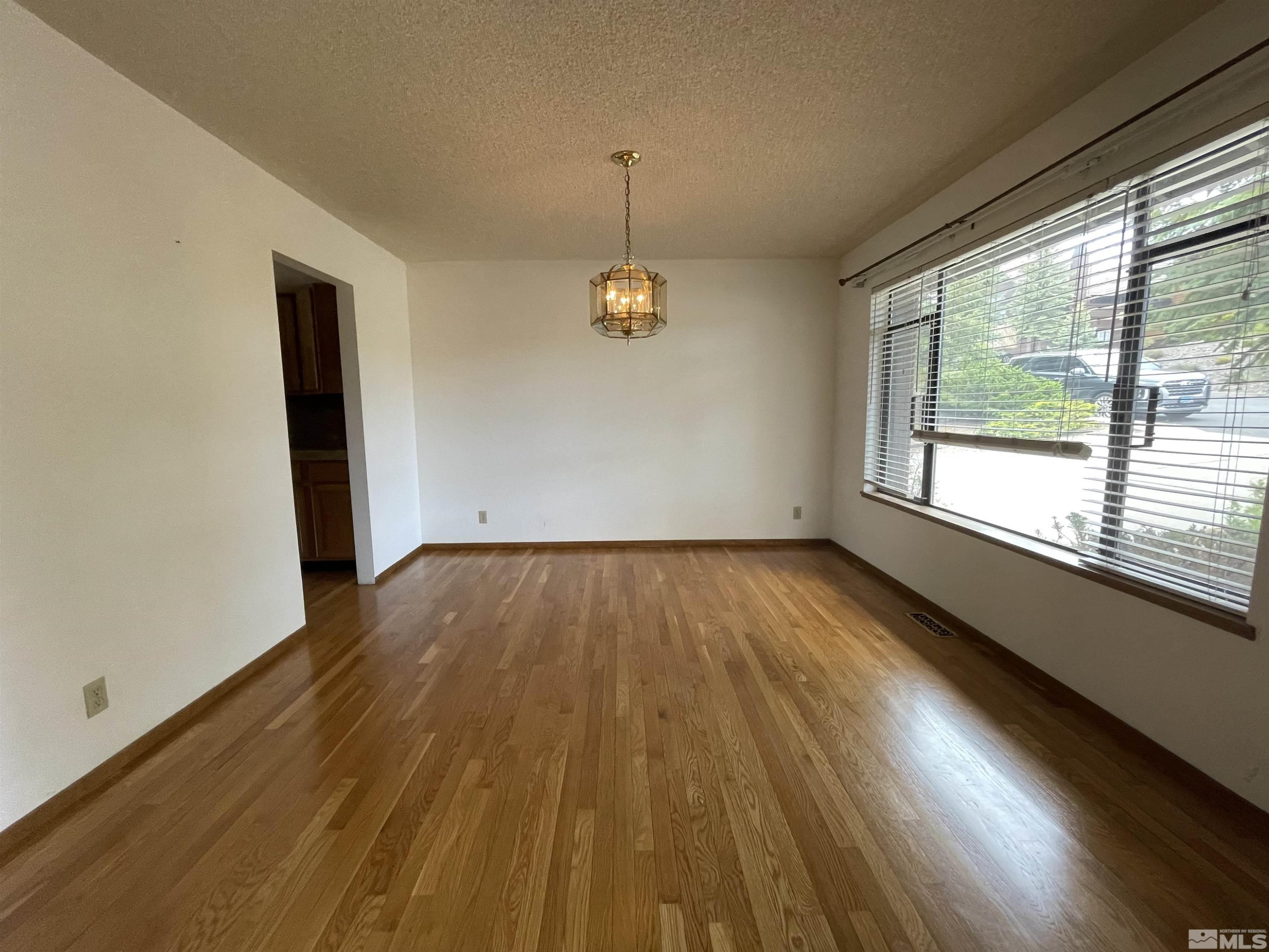 2500 Bryce Canyon Lane Reno, NV 89509 - Photo 7 of 23 a view of empty room with wooden floor and fan