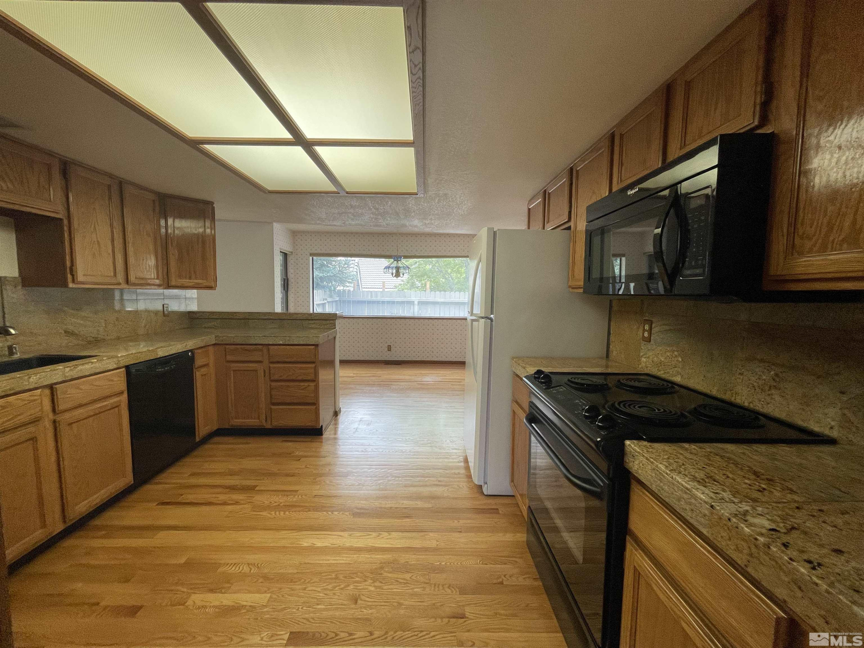 2500 Bryce Canyon Lane Reno, NV 89509 - Photo 9 of 23 a kitchen with stainless steel appliances granite countertop a stove a sink and a microwave