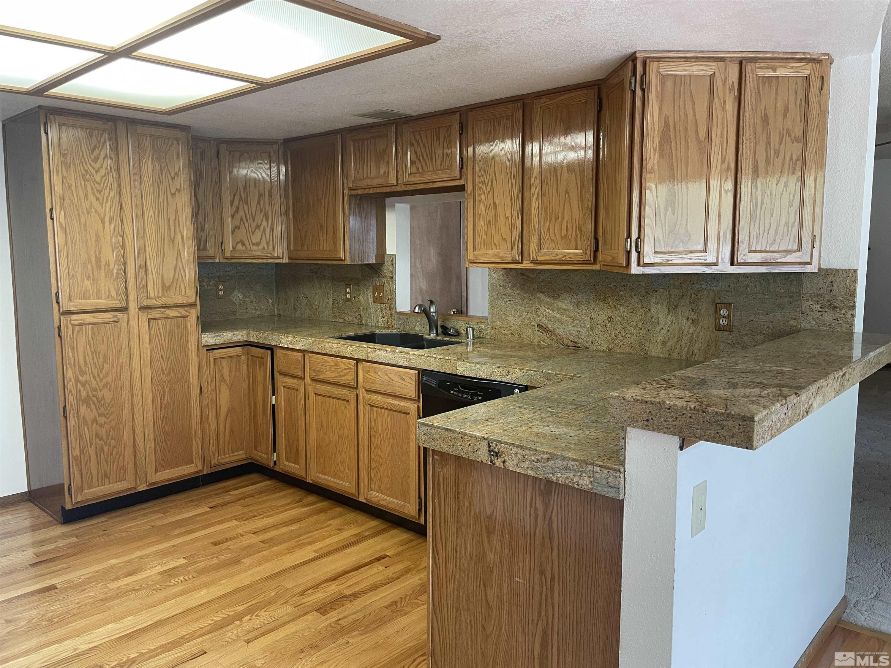 2500 Bryce Canyon Lane Reno, NV 89509 - Photo 10 of 23 a kitchen with a sink cabinets and wooden floor