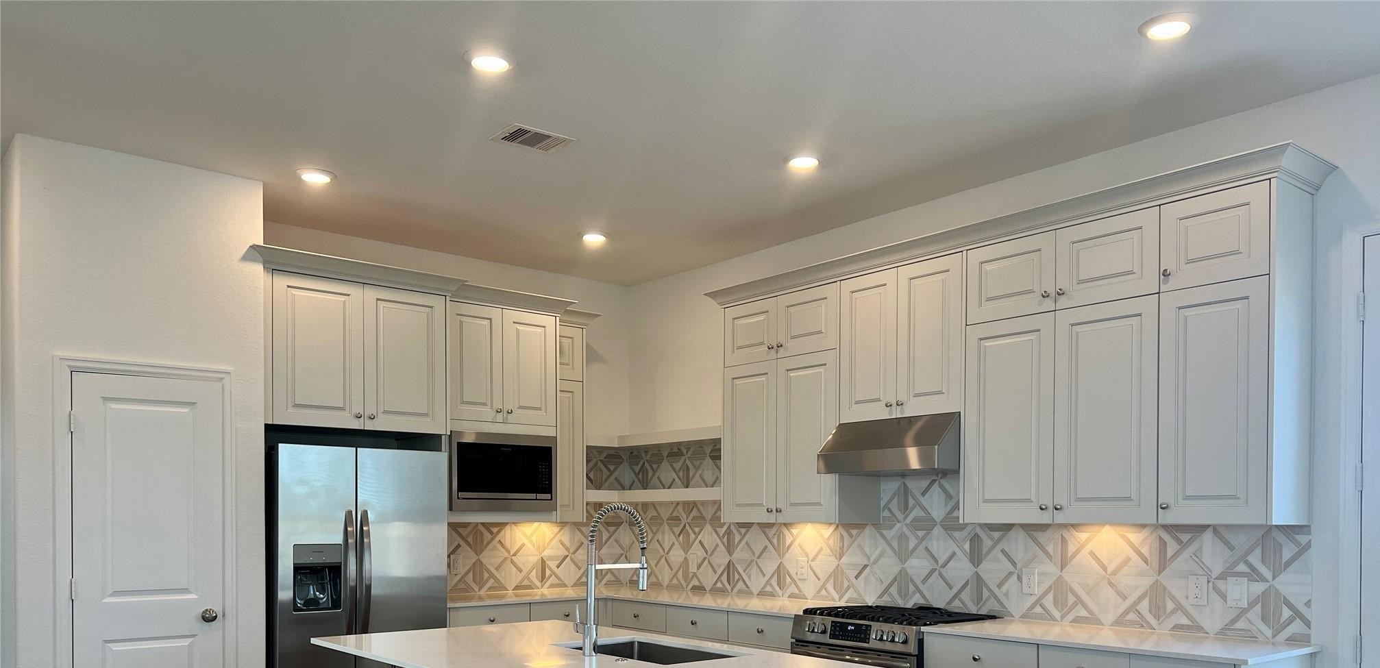 1035 Blue Stone Drive Beasley, TX 77417 - Photo 4 of 24 a kitchen with stainless steel appliances granite countertop a refrigerator and a stove top oven