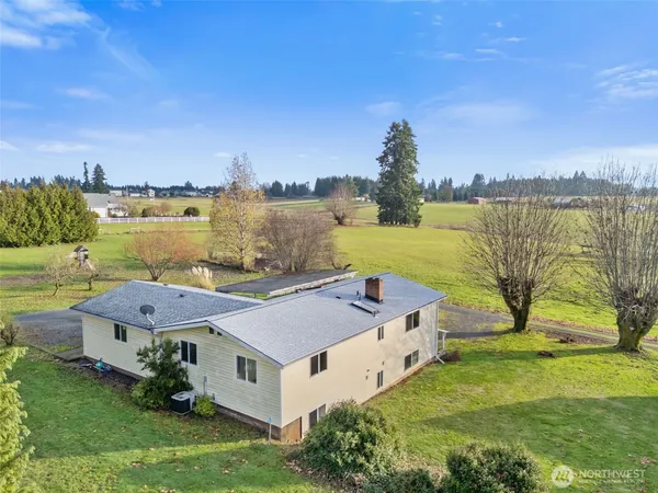 a aerial view of a house with a garden and lake view