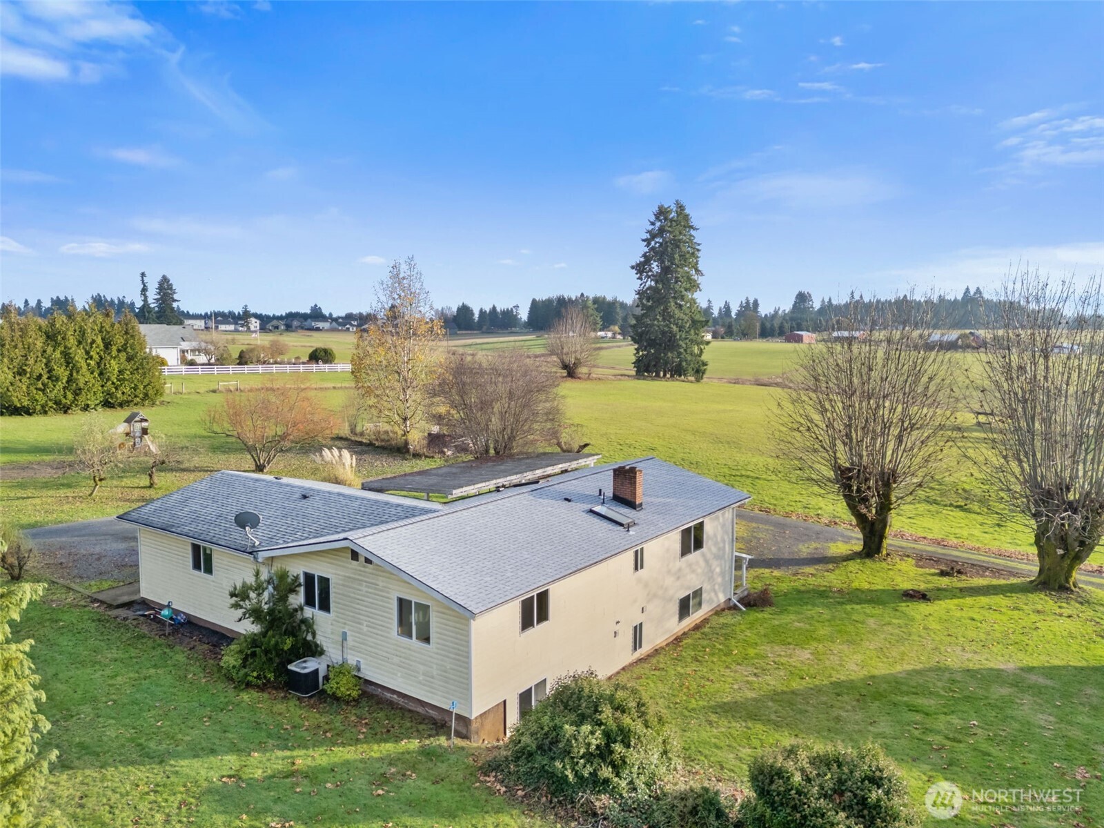 a aerial view of a house with a garden and lake view