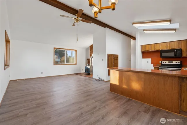 a kitchen that has a sink and a stove top oven