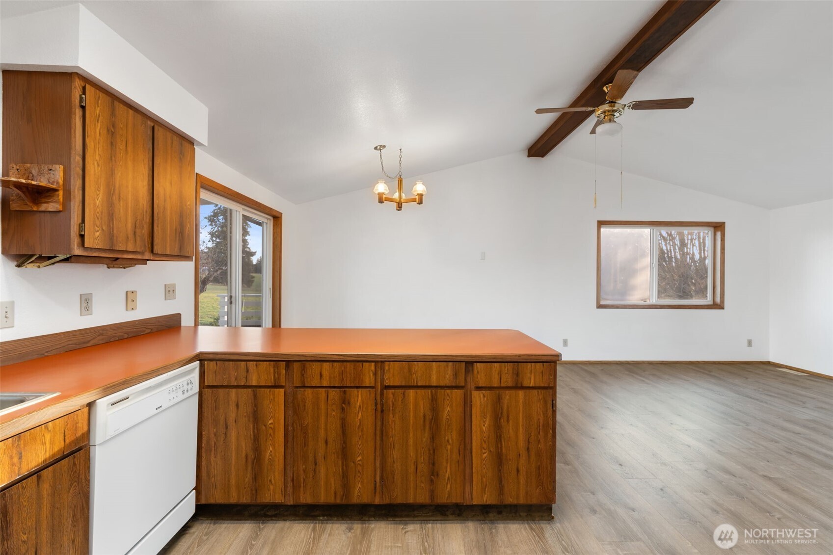 568 A Cemetery Road Winlock, WA 98596 - Photo 15 of 38 a kitchen with stainless steel appliances granite countertop a stove a sink and a microwave with wooden floor