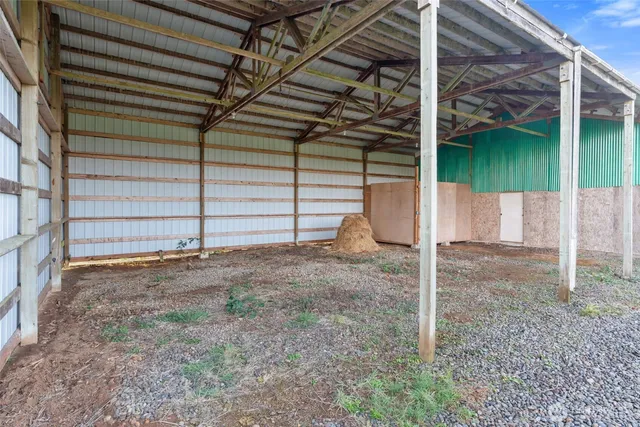 a view of a house with a yard and a large tree