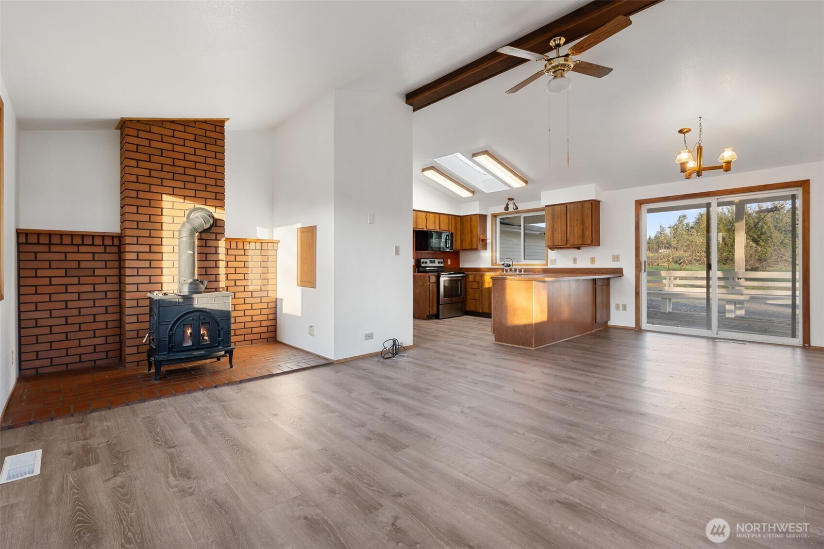 568 A Cemetery Road Winlock, WA 98596 - Photo 9 of 38 a view of a living room and kitchen with furniture wooden floor and windows