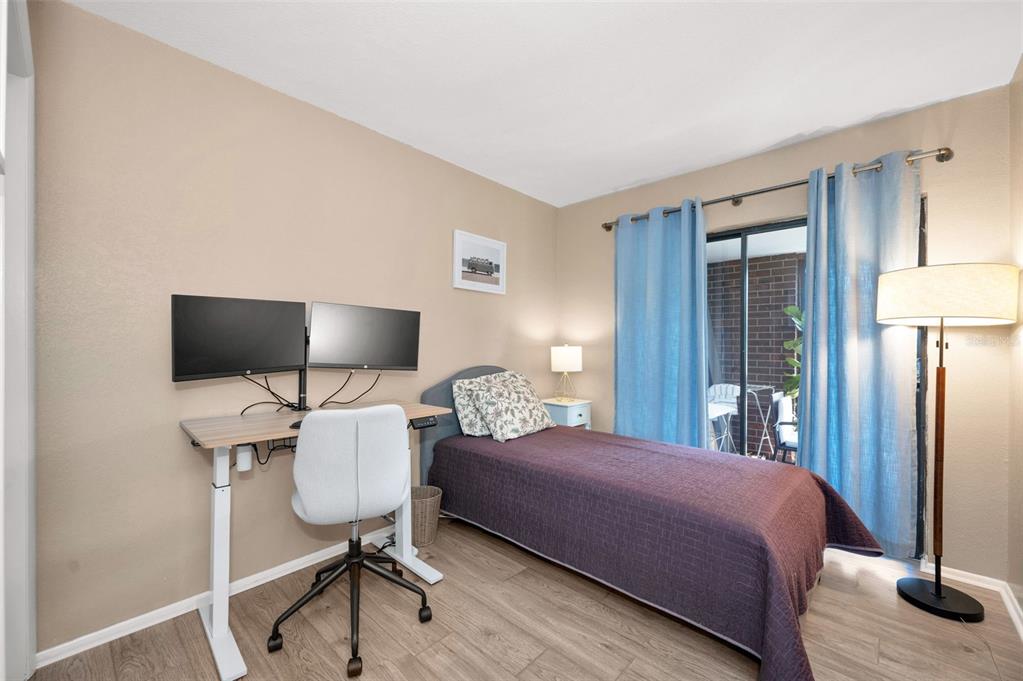 208 Caryl Way Oldsmar, FL 34677 - Photo 22 of 28 a bedroom with a bed tv and table