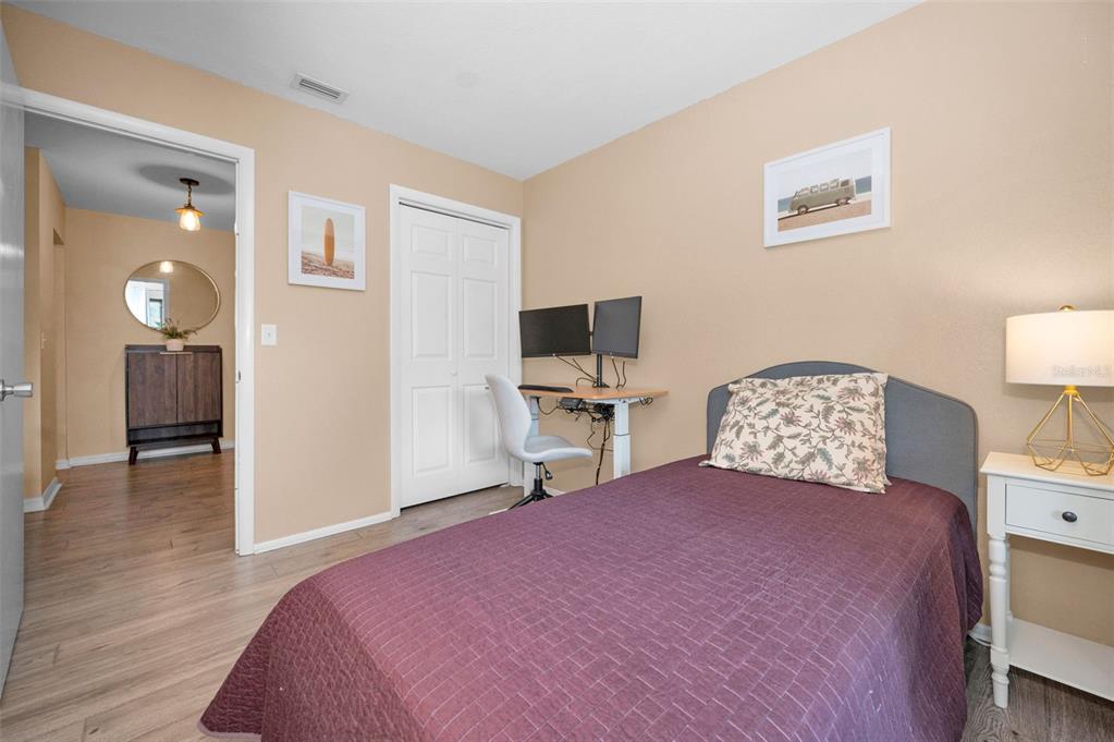 208 Caryl Way Oldsmar, FL 34677 - Photo 23 of 28 a bedroom with a bed and a flat screen tv