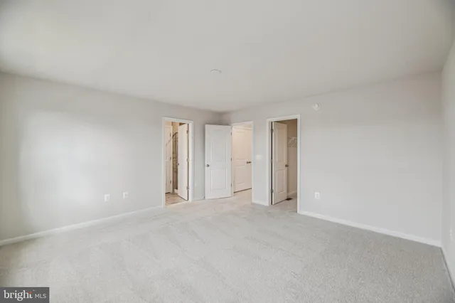 a view of an empty room and a window