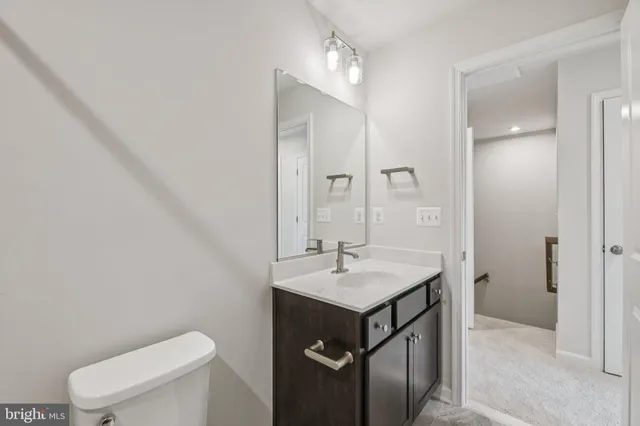 a bathroom with a sink toilet and mirror