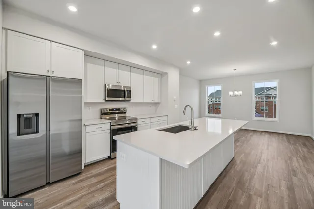 a kitchen with a refrigerator stove and wooden cabinets