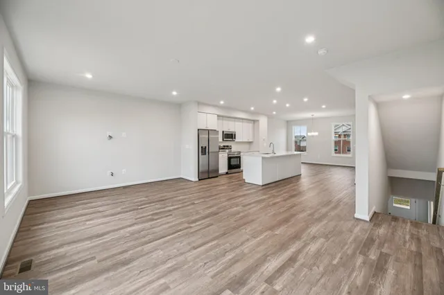 a view of a kitchen with a sink and wooden floor