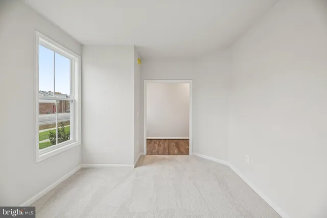 an empty room with windows and closet