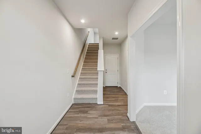 a view of entryway and hall with wooden floor