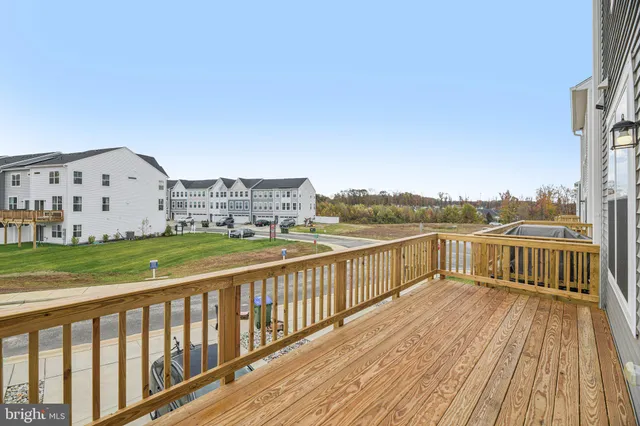 a view of a balcony with wooden floor and city view