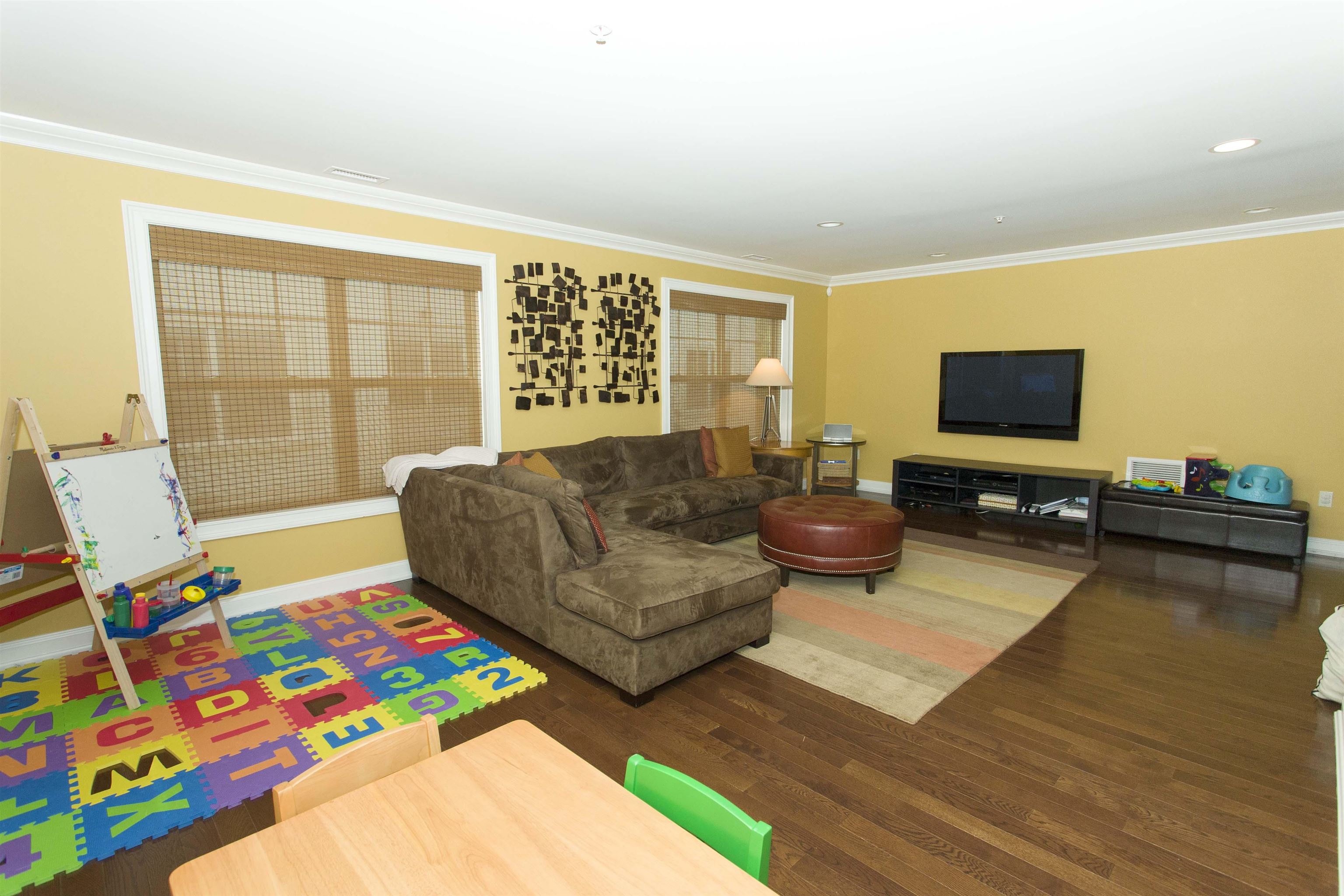 1625 Paterson Plank Road, Unit 24 Secaucus, NJ 07094 - Photo 17 of 20 a living room with furniture and a flat screen tv