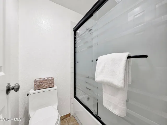 a bathroom with a shower and toilet
