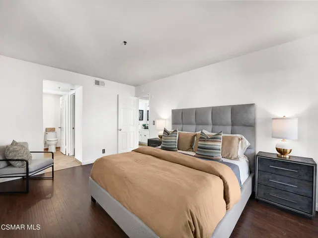 a bedroom with a bed and lamp