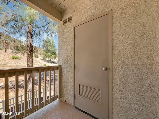 a view of a porch with wooden floor