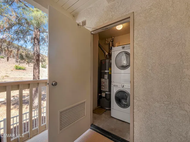 a utility room with sink dryer and washer