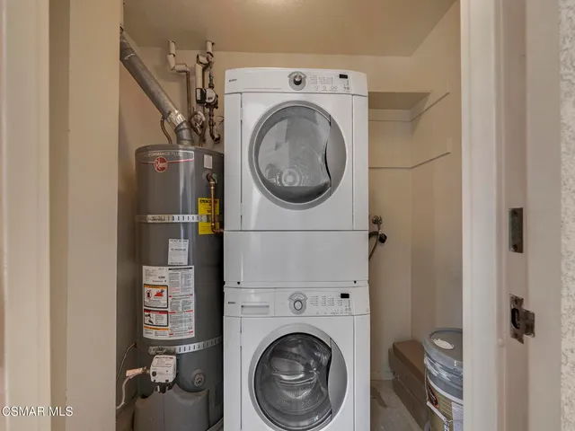 a view of a storage & utility room with dryer and washer
