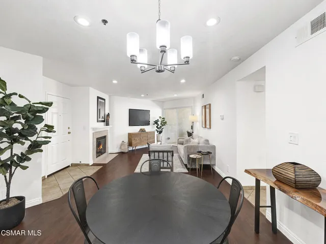 a view of a dining room with furniture wooden floor and chandelier