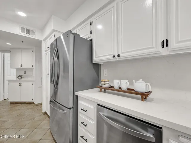a kitchen with appliances cabinets and a counter top space