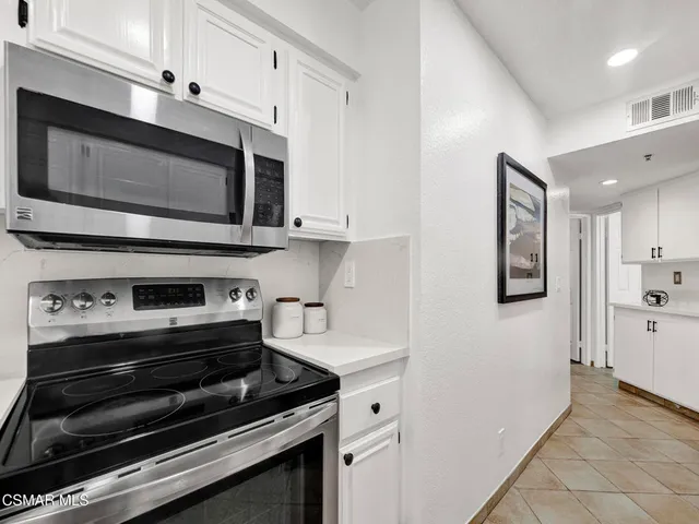 a kitchen with appliances and cabinets