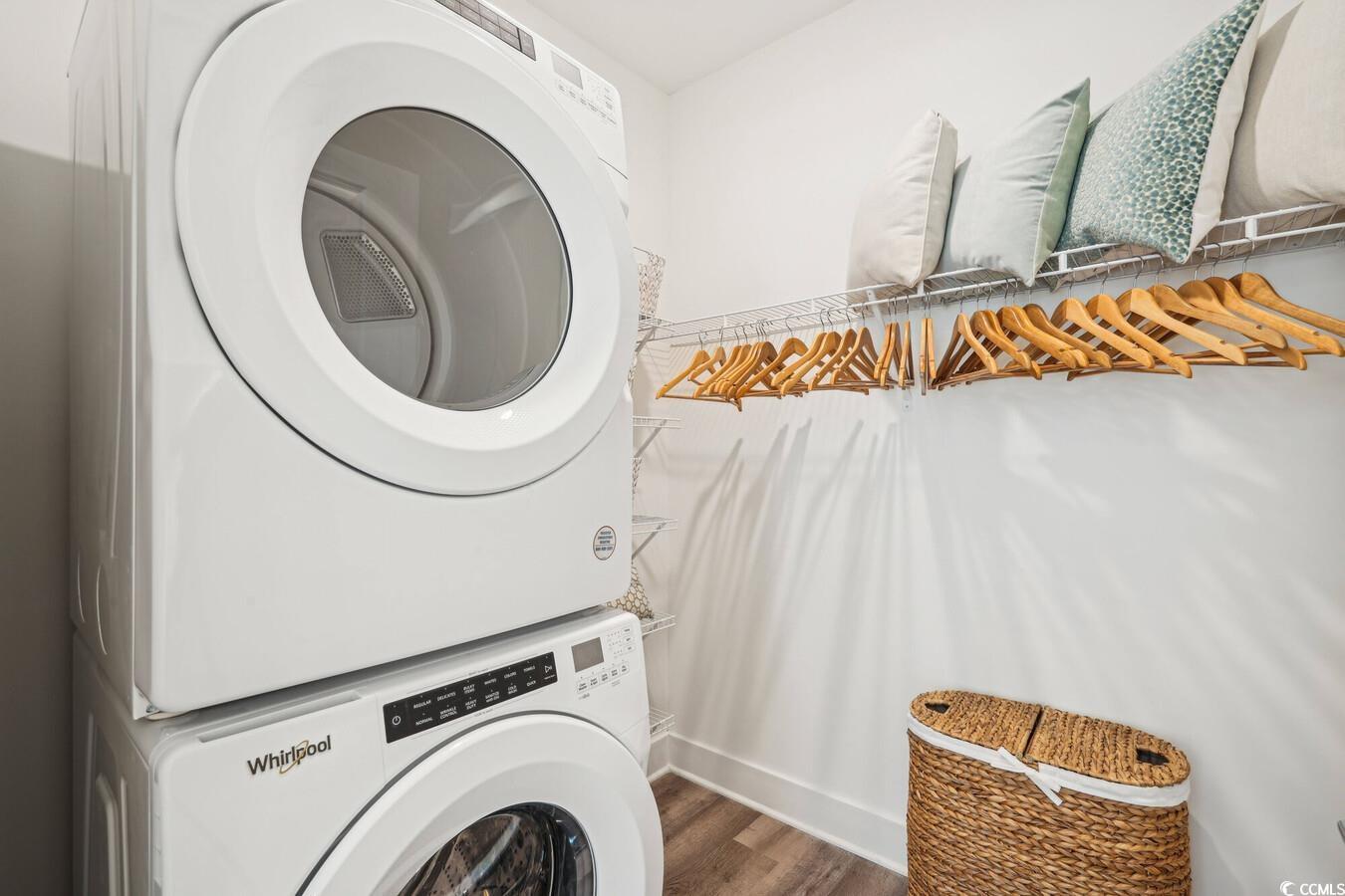 331 Pickwick Drive, Unit A2 Myrtle Beach, SC 29588 - Photo 19 of 39 Clothes washing area featuring hardwood / wood-style floors and stacked washing maching and dryer