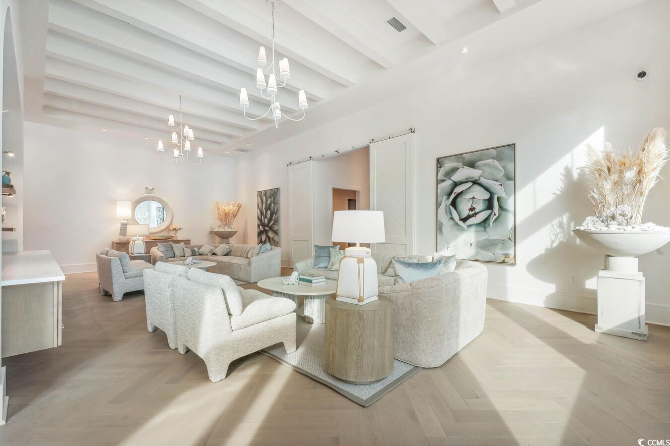 331 Pickwick Drive, Unit A2 Myrtle Beach, SC 29588 - Photo 34 of 39 Living room with beamed ceiling, a notable chandelier, a towering ceiling, and light parquet floors