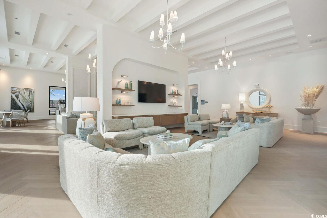 331 Pickwick Drive, Unit A2 Myrtle Beach, SC 29588 - Photo 10 of 39 Living room with beam ceiling, light parquet floors, and an inviting chandelier