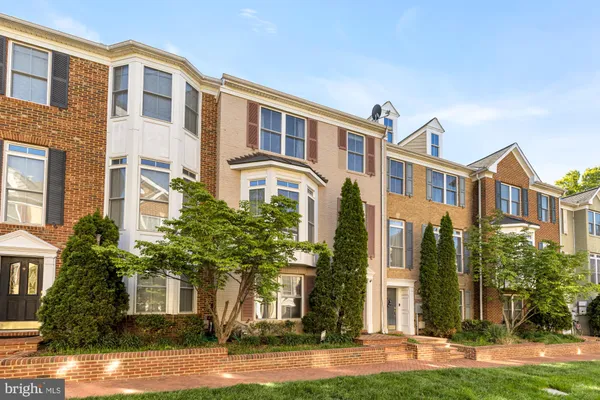 a front view of a residential apartment building with a yard