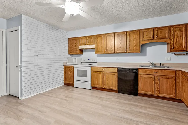 a kitchen with stainless steel appliances granite countertop a stove sink and cabinets