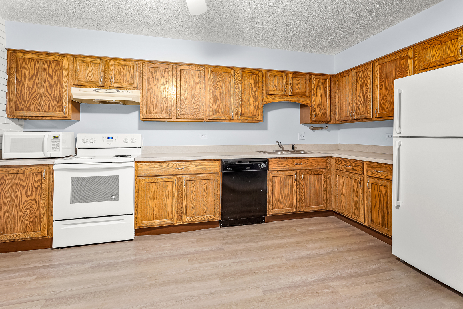 216 Madison Street, Unit 1A Joliet, IL 60435 - Photo 7 of 13 a kitchen with a stove sink and cabinets