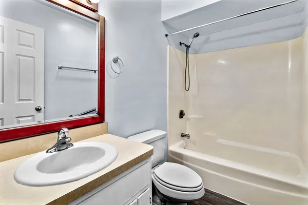a bathroom with a sink toilet and shower