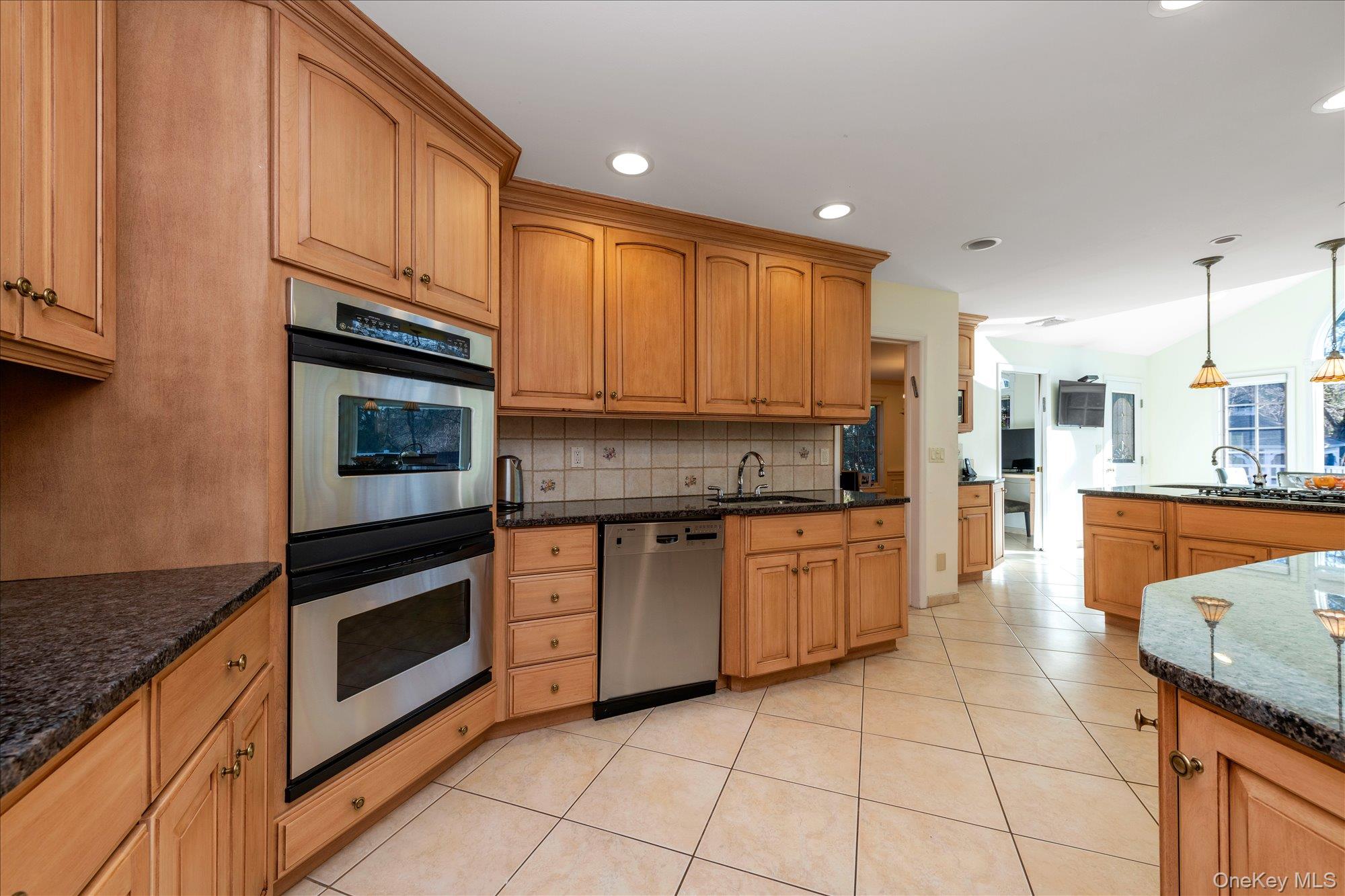 200 Hummingbird Drive East Hills, NY 11576 - Photo 14 of 29 a kitchen with stainless steel appliances granite countertop a stove a sink and a microwave