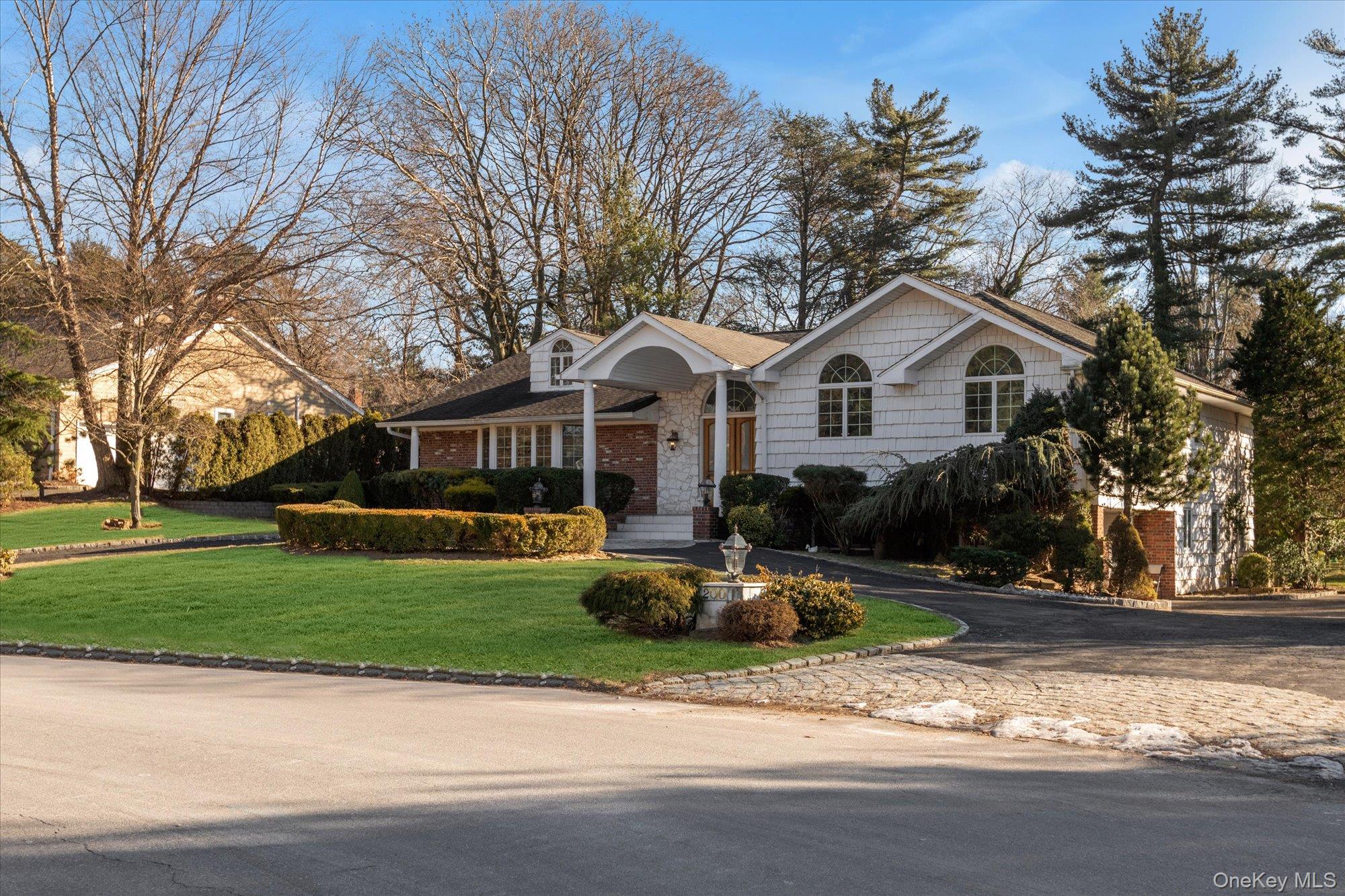 200 Hummingbird Drive East Hills, NY 11576 - Photo 5 of 29 a front view of a house with a garden and trees