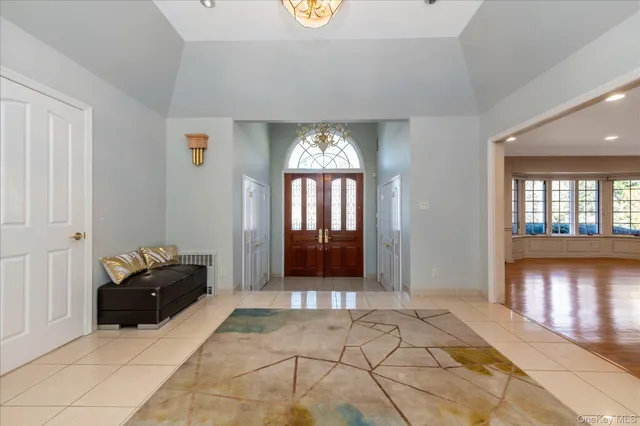 a living room with a couch and a chandelier