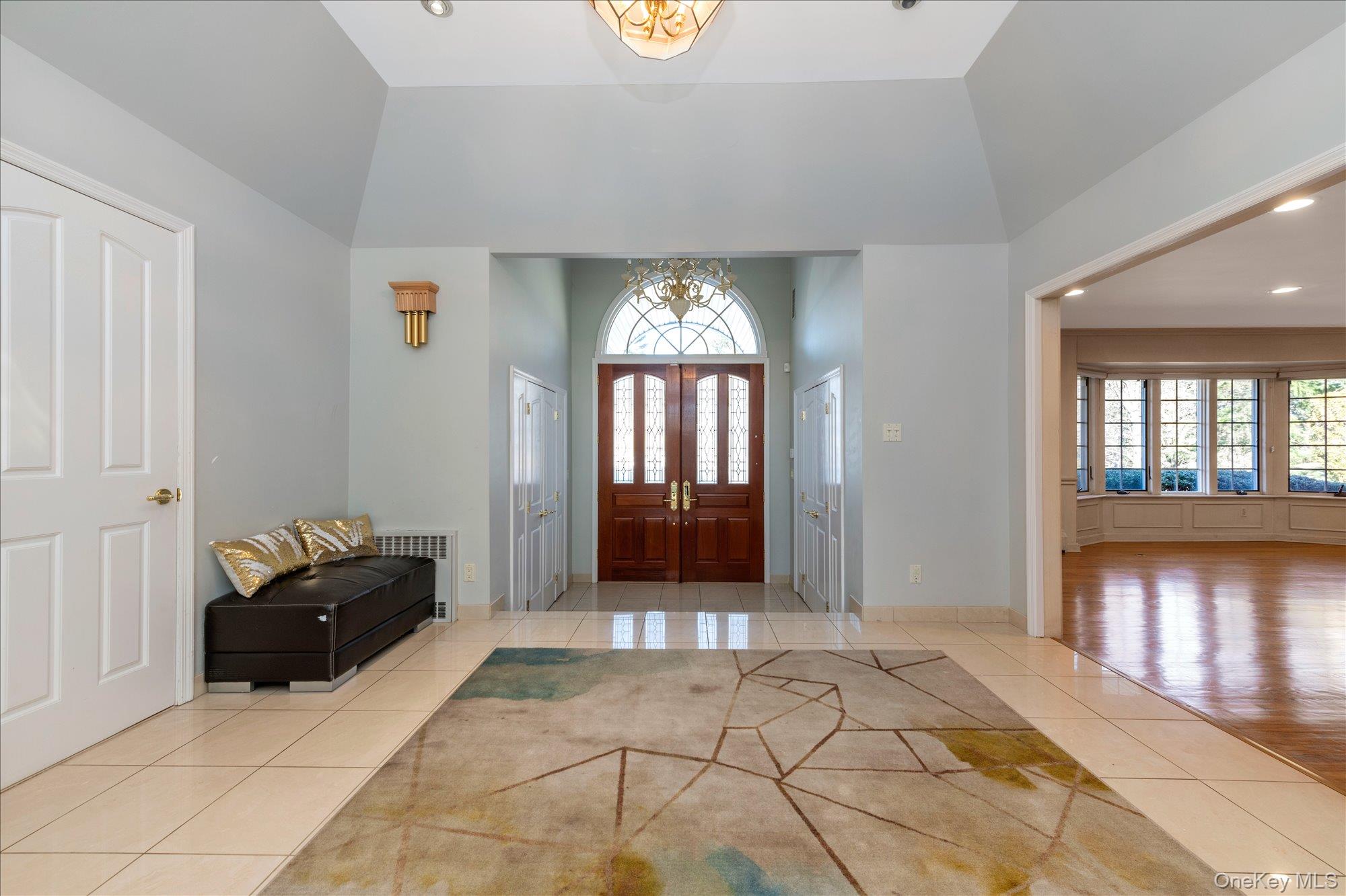 200 Hummingbird Drive East Hills, NY 11576 - Photo 6 of 29 a living room with a couch and a chandelier