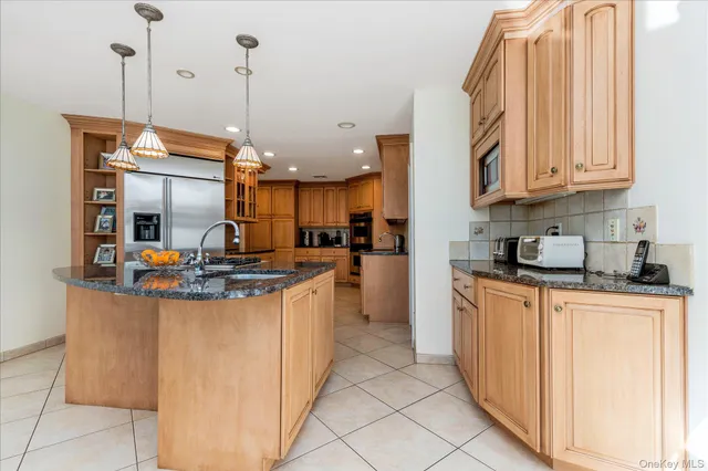 a kitchen with stainless steel appliances granite countertop a sink and cabinets