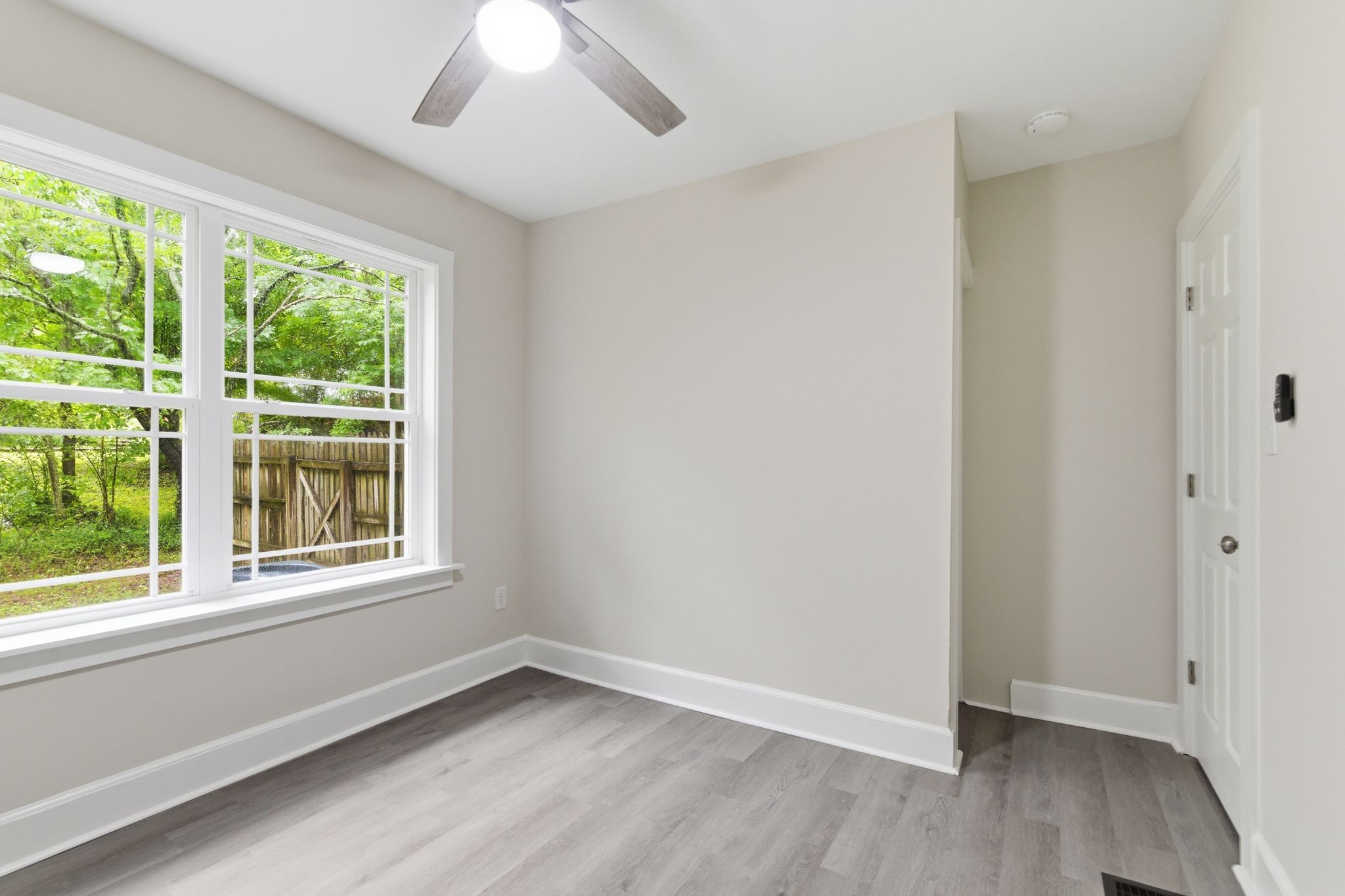 305 South Irwin Street Manchester, TN 37355 - Photo 22 of 40 an empty room with wooden floor and windows