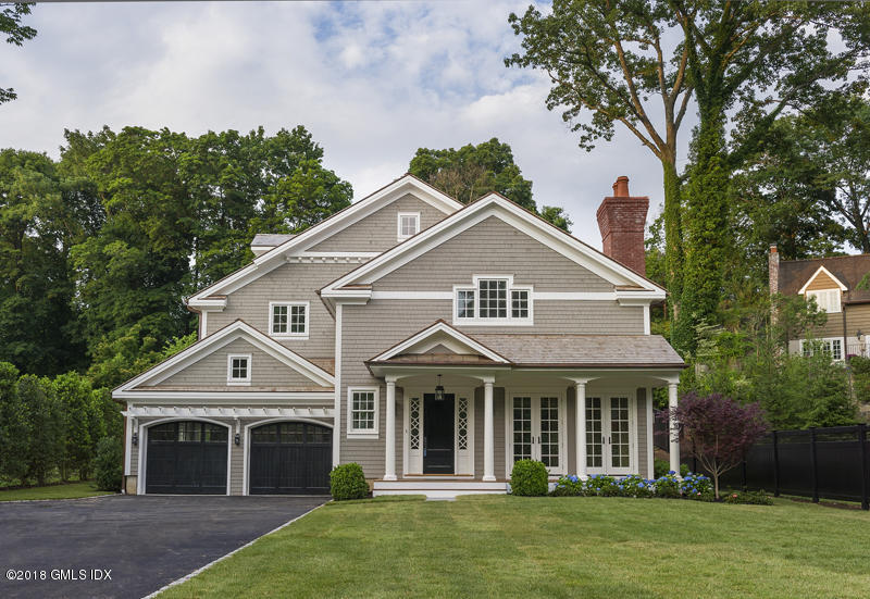 a front view of a house with a garden and porch