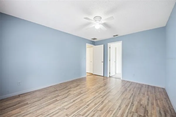 a view of an empty room with wooden floor
