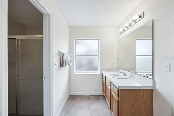 a bathroom with a bathtub sink and mirror