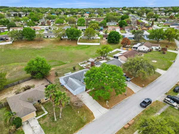 an aerial view of a house with garden space and street view