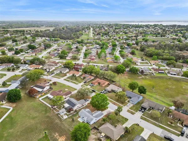 an aerial view of residential houses with outdoor space and river